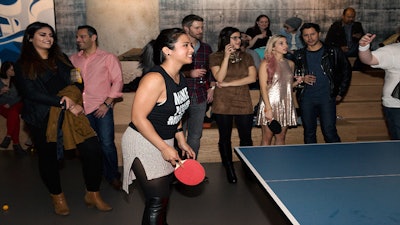 Make your move! A model plays ping pong at SPiN Chicago.