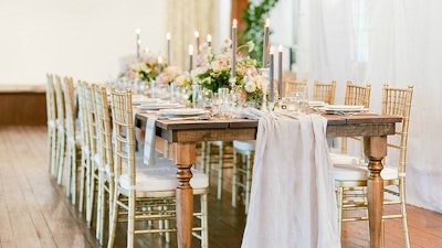 Beautiful farm tables looked great in the ballroom for an elegant wedding dinner.