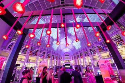 Glowing pink cherry blossoms hung from a trellis in the upper oculus overlooking the main event.