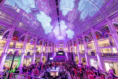 Inspired by the height of cherry blossom trees, the event designers chose to project the flowers on the ceiling of the atrium.