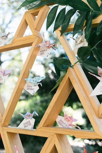 Escort cards attached to paper cranes were displayed on a large triangular frame at a wedding designed by Janda. “It was a work of art that kept guests talking and talking,” she says.