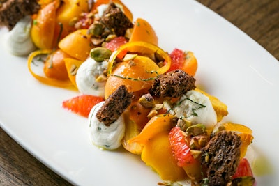 The beet salad by executive chef Tanya Baker at the Boarding House in Chicago features herbed goat cheese, cashew streusel, and a carrot reduction.