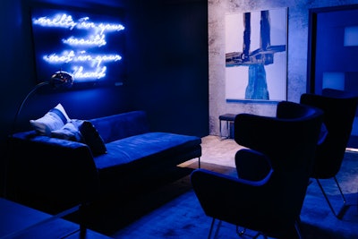 The blue room was meant to resemble a bachelor pad and featured contemporary artwork, a ping-pong table, and neon signage of the candy brand's tagline that served as a photo op for guests.