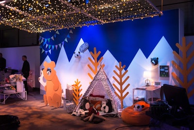 Vignettes throughout the space were modeled after the collection’s themes. At Camp Kiddo, kids could pose for photos by peeking their heads through a bear or fox figure or hang out in a teepee. They could also decorate fabric pennants.