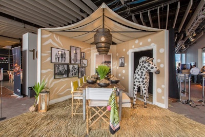 Echo Design's setup evoked a safari sit-down dinner with a thatched rug, canvas director’s chairs, caged pendant lighting, and a zebra pop-in guest.