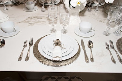 The table settings included silver hammered chargers and orchid-embellished napkin rings by Michael Aram, which were provided by Bloomingdale’s.