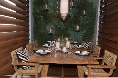 Ralph Lauren Home teamed up with lighting partner Visual Comfort to create a resort-theme vignette, which featured a living wall, teak chairs, and zebra-patterned pillows.