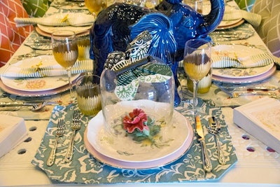 The tabletop featured whimsical details, including playful elephant ceramics, floral dinnerware, and greenery garland down the center of the table.
