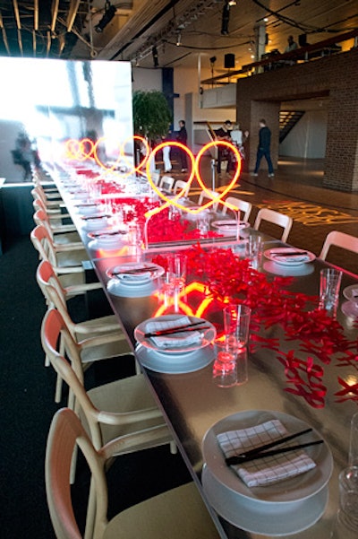 Neon hearts, which are created by joining two AIDS-awareness ribbons, were the focus of Gensler and 3form's vignette, which featured Herman Miller furniture and a concrete table.
