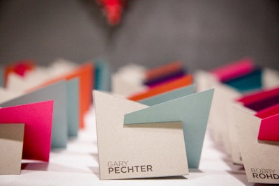 Instead of standard folding escort cards, Jayne Weddings designed interlocking place cards to create a fun, colorful welcome for wedding guests.
