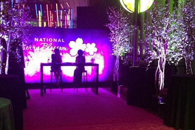 Cherry blossom trees flanked the pink carpeted entrance as guests arrived.