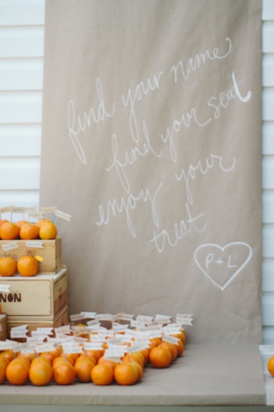 Clementines served as place cards with guests’ names attached at a Ruie & Grace-designed wedding in Lewisburg, Pennsylvania.