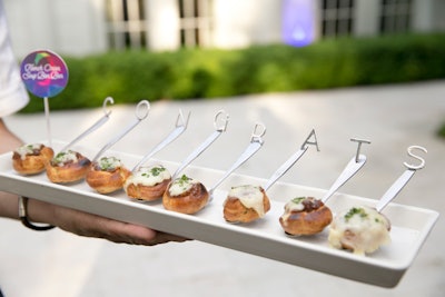 At a graduation party designed by Chicago-based Christina Janda Design & Events, serving spoons with French onion bonbons spelled out “congrats” on a tray and incorporated the guest of honor’s favorite food in a fun, unexpected way.