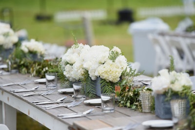 Guests at the Stella Artois event dined at several long, farm-style tables, which had no linens—but were instead topped with abundant white flowers.