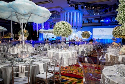Patel decorated tables with alternating arrangements of flowers and clouds. He also hung custom chandeliers that added an industrial element to the design scheme.