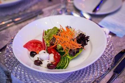 The dinner started with a salad course (pictured) of three types of lettuce, fresh mozzarella, olives, cherry tomatoes, and shredded carrots. The main course was a steak-salmon duo; dessert was an individual baked Alaska.