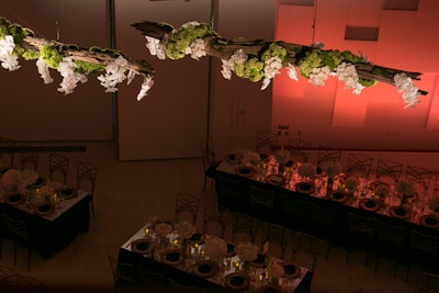 Additional decor included hanging floral installations made up of white flowers, moss, and driftwood.