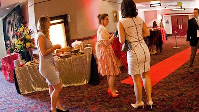 Surprise guests with transformed hallways complete with tables for registration, catering, and gift bags.