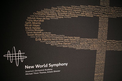The gala honored 1,000 New World Symphony (N.W.S.) alumni. On the step-and-repeat, the names of all of those alumni comprised the N.W.S. logo.
