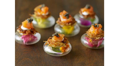 Mini potato latkes with smoked salmon, dill crème, and caviar.