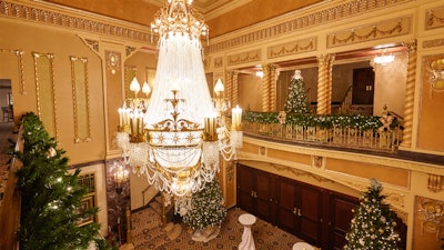 The 18-foot Baccarat crystal chandelier illuminates the holiday decorations.