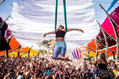 The art collective Do Lab's colorful stage provided shade over fans and included strategically placed misters and flower-adorned water guns to keep guests cool in the desert heat.