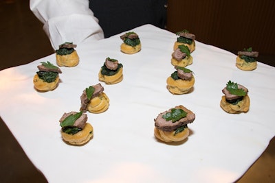 During cocktails, Bite served passed canapes, such as steak popovers with charred rib eye, creamed spinach, and glazed bacon.