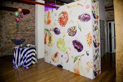 To serve fresh fruit, Chicago catering firm Limelight inserts skewers into a decorative wall featuring colorful wallpaper that can be customized for any event. Guests then dip the fruit into accompanying sauces.