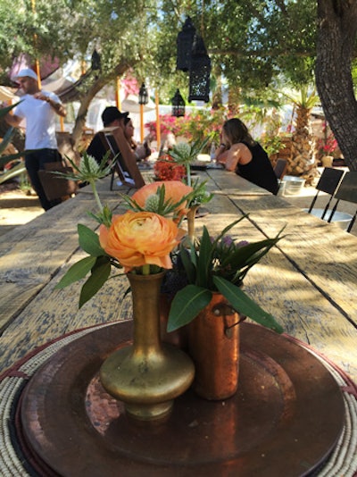 For an event known as the Retreat at Palm Springs' Korakia Pensione during Coachella's first weekend, a long rustic table was set with bohemian touches like blooms in metallic vases topping trays.