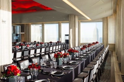Following cocktails and exhibition viewing, guests were ushered into the Rainbow Room's adjacent SixtyFive restaurant for a seated dinner. There, three long tables lined with red rose centerpieces offered 180-degree views of the New York skyline. Each of the dinner tables was sub-divided using designated placards that were inspired by the world of Montblanc travels.