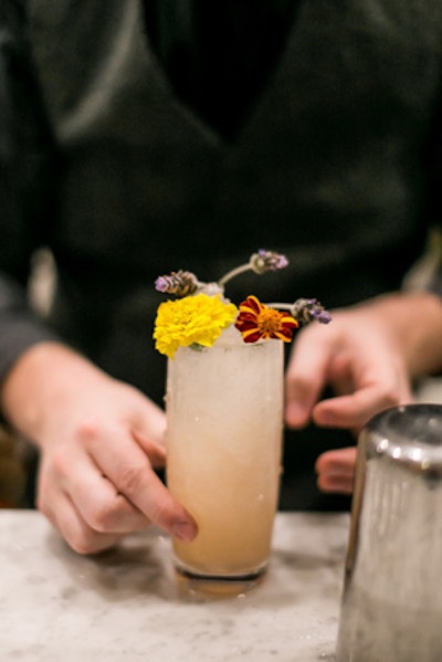 Patina servers carried craft cocktails that included ingredients from nature, as well as organic garnishes such as flowers. For instance, “La Mariposa” was a tequila Collins with chamomile-infused tequila, lavender simple syrup, lime juice, and soda water. “El Lobo” was an Old Fashioned with tequila, agave, and orange bitters, garnished with orange twists.