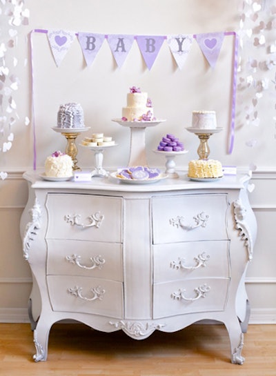 The party included a dessert table with home-baked sweets all in a purple color scheme, arranged under a purple bunting.