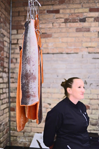 Toronto-based Eatertainment offers an action station focused on serving salmon gravlax. The raw fish hangs from hooks suspended above the station.