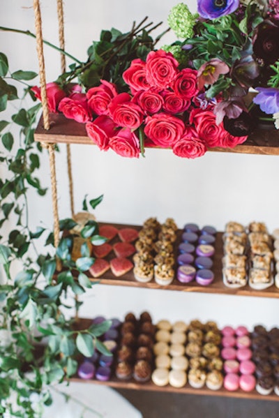 Vines trailed from the hanging display, and sprays of vibrant florals on the hanging shelves complemented the colors of detailed one-bite desserts from Beverly's Bakery.