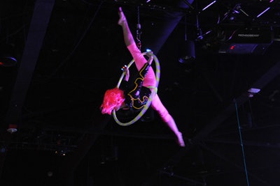 An acrobat dressed in a bright fluorescent costume performed in a hoop suspended from the ceiling at the Gridiron Gala.
