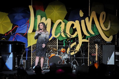 The evening's program featured a performance from singer Vanessa Williams. Her set included the songs 'Colors of the Wind' and 'Save the Best for Last.' The backdrop featured an 'Imagine' sign tucked into a collage of umbrellas and kites.