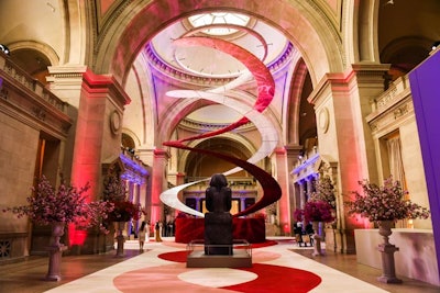 At the center of the Met's Great Hall, the information desk was shrouded in red roses while a 65-foot double helix rose to the top of the ceiling, anchored in place at a rigged point. One strand comprised 250,000 silk roses while the other featured laser-cut off-white lace—both of which got lighter in hue as they extended into the dome. 'This was my first time using artificial roses and my first time hanging something rigged from the ceiling,' said Raul Avila, the Met Gala's long-standing producer. 'Lightweight was key so as not to exceed [the weight restriction of] 1,500 pounds.'