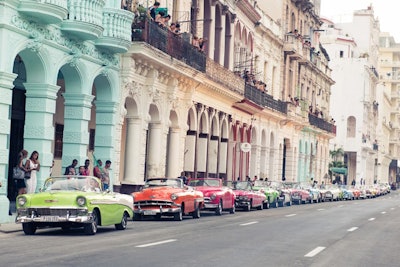 Guests were chauffeured to the show in more than 100 brightly colored 1950s American convertibles rented for the evening. The vintage cars of Cuba appeared as a print on several gowns, including a flowing dance dress that featured candy-colored prints of Buick, Oldsmobile, and Cadillac cars.
