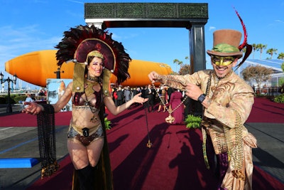 Costumed performers strung beads on guests as they made their way off of ferries that had carried them from the parking lot.