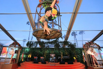 Entertainers performed in birdcage-style decor pieces above the stage.