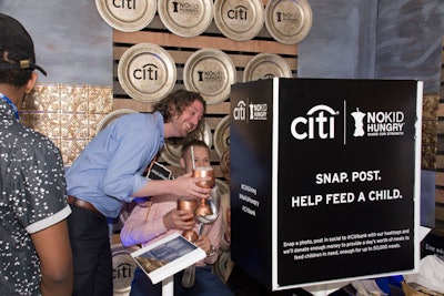 Guests posed with their cocktails and props at the Citi photo booth. For every photo visitors shared on social media, the bank donated money towards the cause.