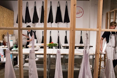 The experience took place at ArtBeam in New York. The setup featured hanging aprons and the Sabra logo.