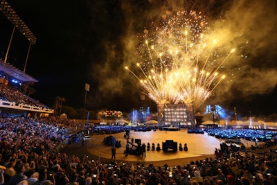 Friends and family sat around the circular stage to watch the two-hour opening ceremonies at ESPN Wide World of Sports Champion Stadium Sunday night. The program, produced by ContinuumLive, included remarks from two injured servicemen, performances by James Blunt and several military groups, remarks from Michelle Obama and Morgan Freeman, and a large fireworks show.