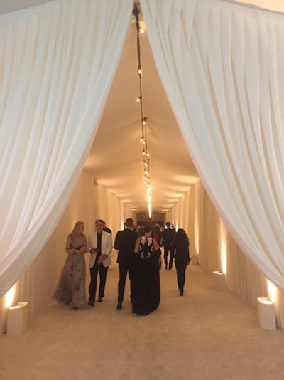 Luxurious white draping strung with Edison-style bulbs formed the entrance to the Elton John AIDS Foundation Oscar party in Los Angeles in February.
