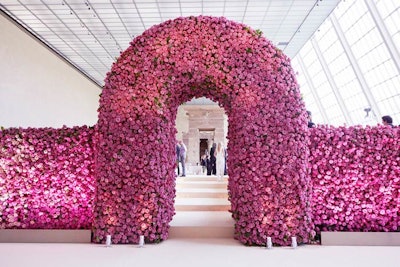 For dinner, guests entered the Temple of Dendur through an arched doorway in a 70-by-20-by-10-foot wall made of 300,000 roses. Because no props could be hung from the ceiling in the room, decor was largely grounded to the floor. To maintain longevity, the roses were conditioned at Avila's Brooklyn studio for three days, then cut on Sunday morning and set in an environment where moisture was closely regulated. The wall was installed later that day.