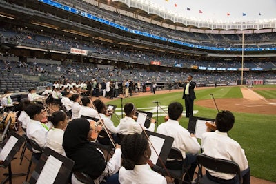 Another new effort saw Robin Hood’s message spread to the Bronx, where the Robin Hood-supported KIPP Academy String and Rhythm Orchestra performed before the New York Yankees game at Yankee Stadium. Two graduating seniors from KIPP NYC College Prep High School threw out the ceremonial first pitch. Also that night, some 30,000 Yankees fans received a Robin Hood-green Yankees cap and 10,000 people served by Robin Hood-funded organizations received free tickets to the game.