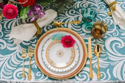 A swirled linen pattern, golden flatware, and jewel-toned florals decked out the “Haute Hacienda” table designed by First Pick Planning and Peony & Plum.