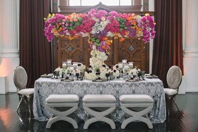 A floral centerpiece added drama suspended over the “Only Love Sees Color” table, designed by Percy Sales Events and Butterfly Floral & Event Design.