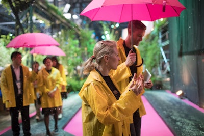 To create an intimate environment for sharing ideas, organizers invited guests to meet while walking together under an umbrella, while a machine overhead sprinkled them with moisture.