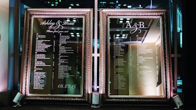 A custom-designed 7.5-foot-tall mirror with escort table names and numbers for a wedding.